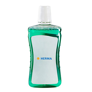Grüne Flüssigkeit in einer transparenten Flasche mit einem weißen Etikett und dem Schriftzug "HERMA".