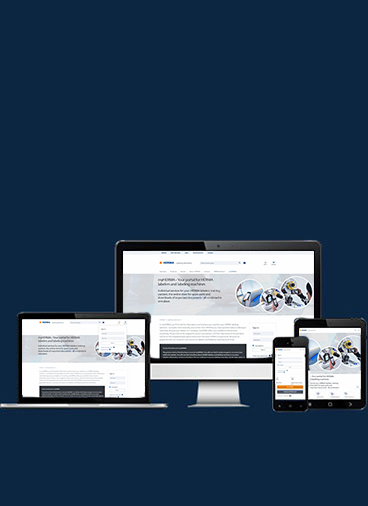 Mehrere elektronische Geräte zeigen eine Webseite mit Informationen zu Fahrzeugtechnologien und -sicherheit.