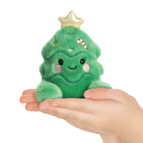 Eine Hand hält ein grünes, plüschiges Weihnachtsbaum-Spielzeug mit einem Lächeln und einer goldenen Spitze.