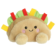 Kuscheltier in Form eines Taco mit einem lächelnden Gesicht, bunten Zutaten und weichem Material.