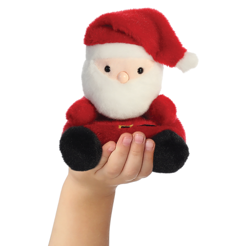 Eine Hand hält eine kleine, plüschige Weihnachtsmannfigur mit rotem Hut und Anzug.