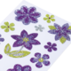 Bunte Glitzerblumen in verschiedenen Formen und Farben auf weißem Hintergrund, darunter lila, grün und gelb.
