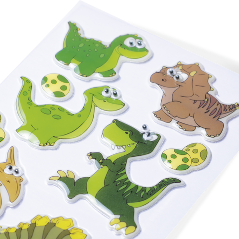 Bunte Dinosaurier-Sticker in verschiedenen Posen, einschließlich Eier und ein Dinosaurier-Hügel, auf einem weißen Hintergrund.
