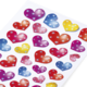 Bunte Aufkleber in Herzform, in verschiedenen Farben und mit glitzernden Sternen verziert, auf weißem Hintergrund angeordnet.