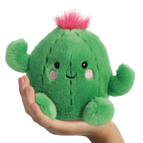 Grünes, kuscheliges Kaktus-Spielzeug mit einem lächelnden Gesicht und rosa Blüte, gehalten in einer Hand.