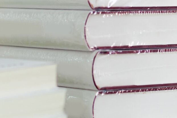 In Folie eingeschweißte Bücher, als Stapel, Bildmotiv für Buchetikettierung mit ablösbaren Etiketten von HERMA, Querformat