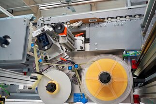 Maschine zur Verarbeitung von Materialien mit Rollen und mechanischen Komponenten, die für industrielle Anwendungen ausgelegt ist.
