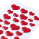 Rote Herzaufkleber auf einem weißen Blatt, in verschiedenen Größen und Formen angeordnet.