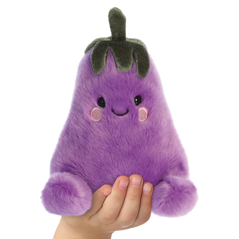 Lila, plüschige Aubergine mit einem lächelnden Gesicht und runden Wangen, wird von einer Hand gehalten.