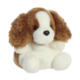 Plüschhund mit braun-weißen Fell, großen Augen und langen Ohren, sitzt aufrecht mit einem neutralen Ausdruck.