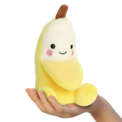 Eine Hand hält ein gelbes, plüschiges Bananen-Spielzeug mit einem lächelnden Gesicht und rosa Wangen.