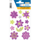 Bunte, glitzernde Blumenaufkleber in verschiedenen Formen und Größen, hauptsächlich in Lila und Grün, auf einem weißen Hintergrund.